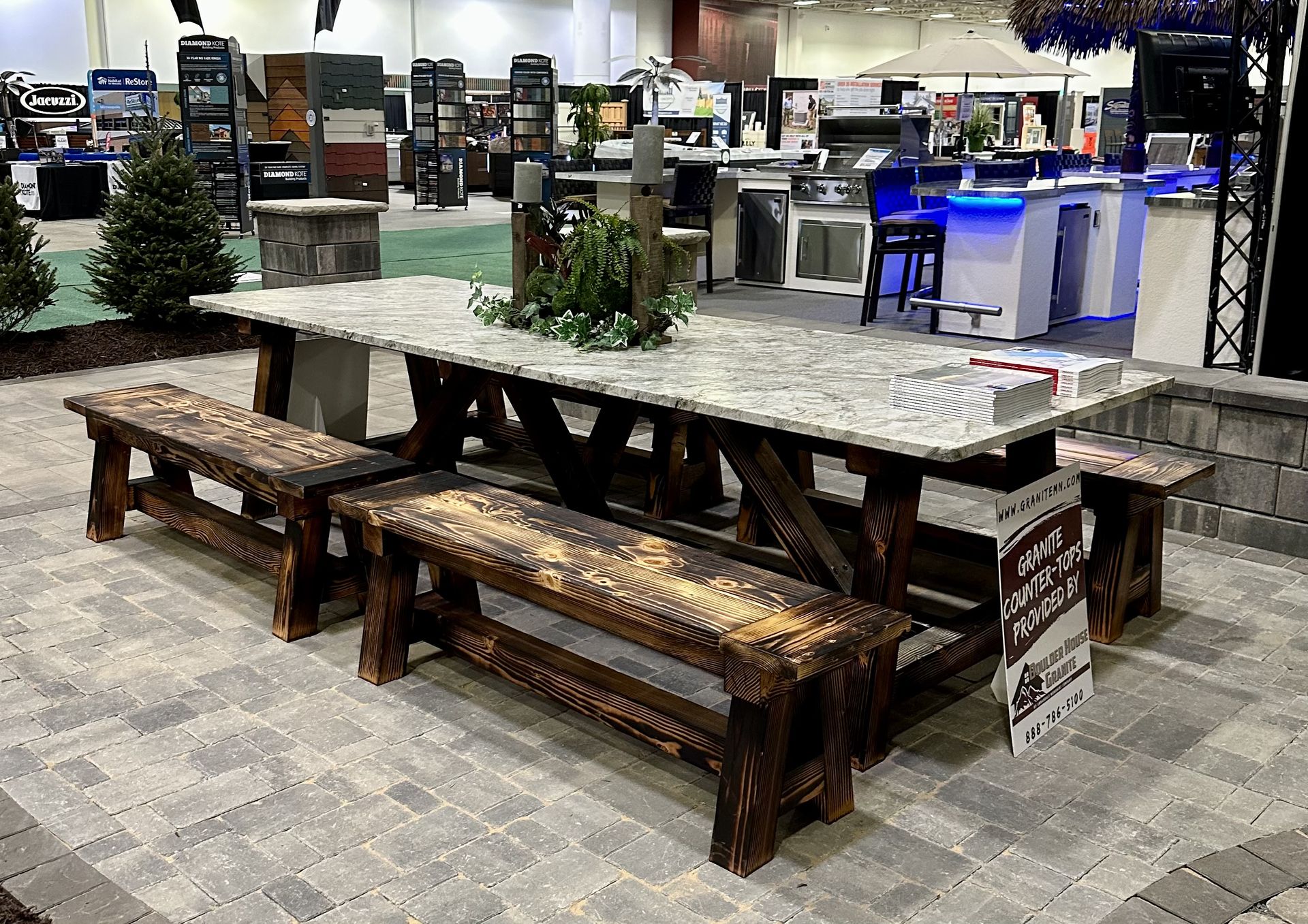 A handcrafted wooden outdoor dining table paired with matching benches, perfect for hosting gatherings in a natural setting.