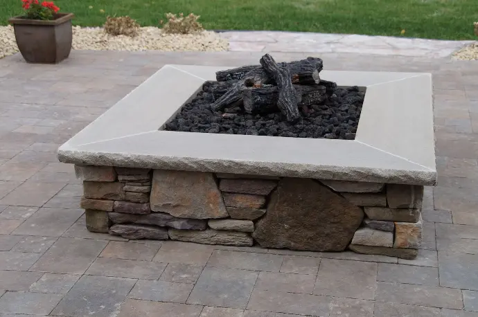 A sleek, modern fire pit with a concrete base, adding a stylish and functional element to the outdoor living area.