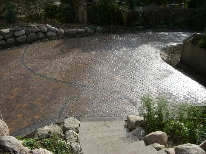 A custom-designed stone paver driveway with elegant edging, adding a refined touch to the property’s entrance.