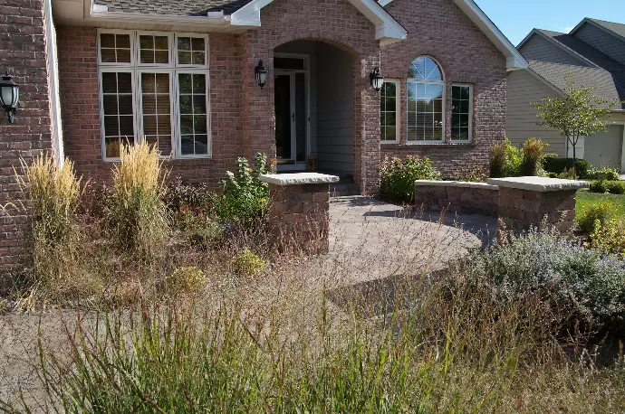 A wide natural stone paver walkway leading to the front door, creating a welcoming entrance.