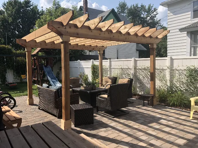 A custom wooden trellis providing shade over a dining set, making for a stylish and functional outdoor dining area.