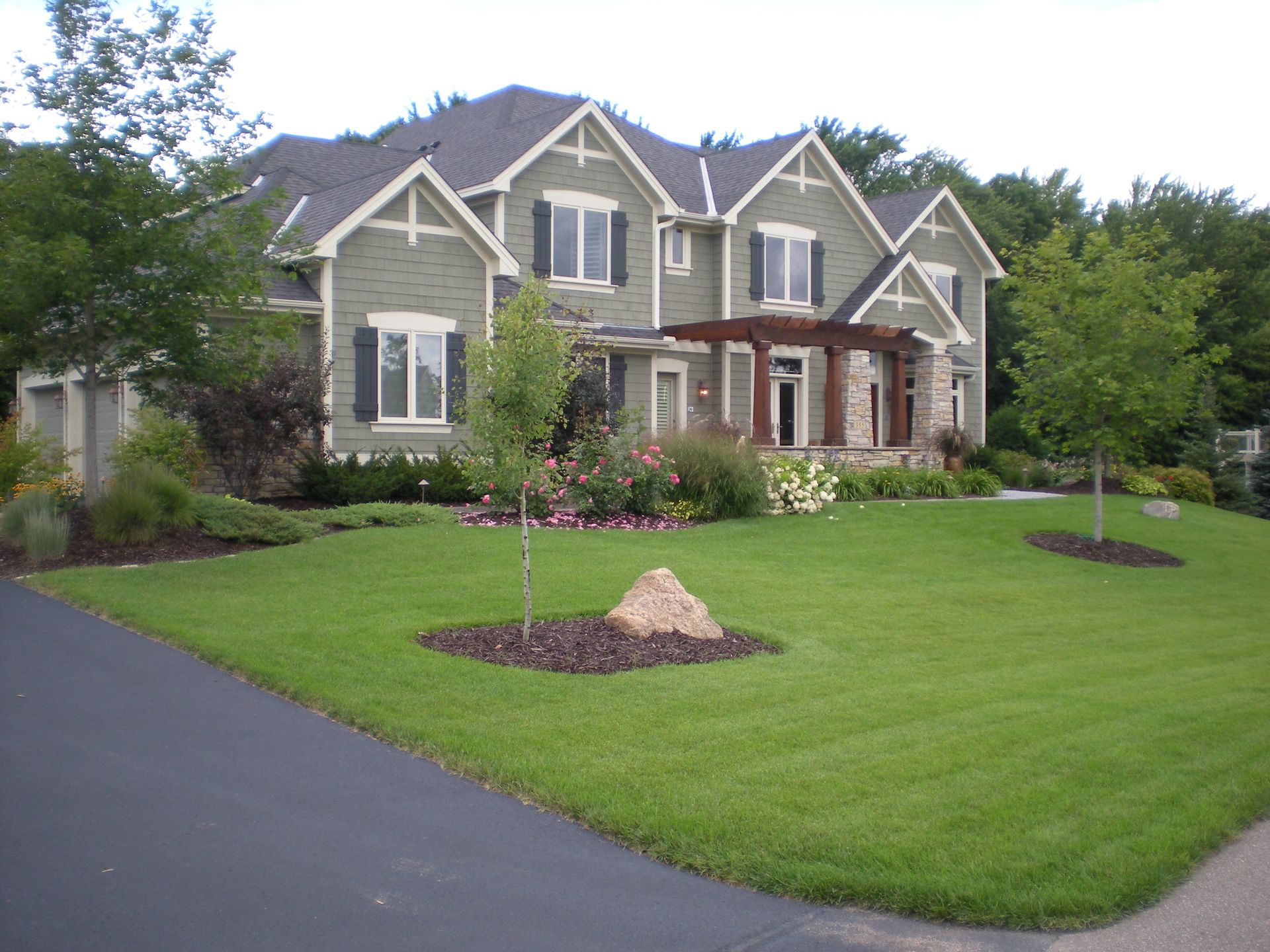 A custom sod installation on a sloped yard, creating a lush, green landscape with expert care.